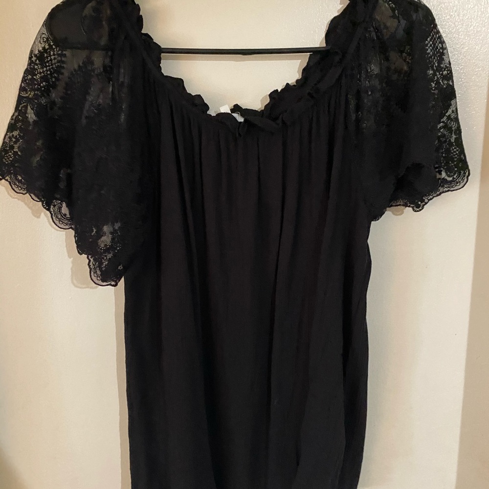 Black top with lace sleeves.